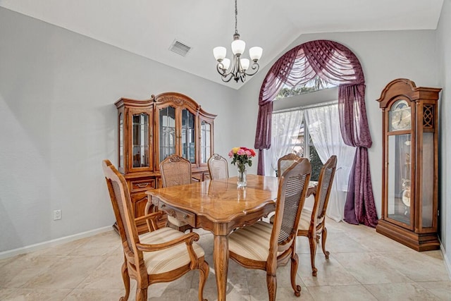 tiled dining space with lofted ceiling and a chandelier