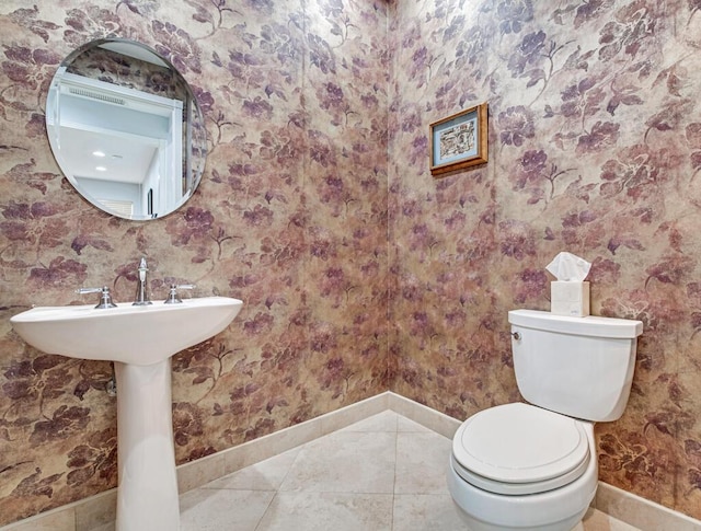 bathroom with tile patterned flooring and toilet