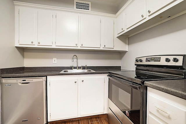 kitchen featuring dark hardwood / wood-style floors, white cabinetry, sink, and appliances with stainless steel finishes