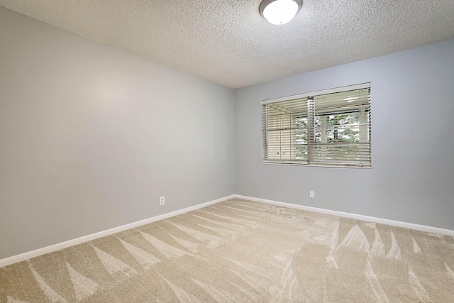 carpeted spare room featuring a textured ceiling