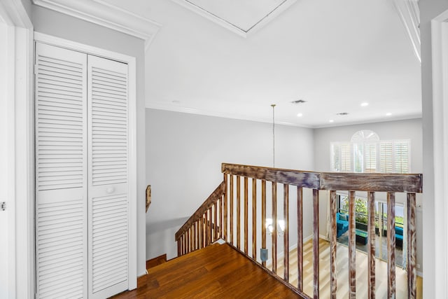 corridor featuring hardwood / wood-style floors and crown molding