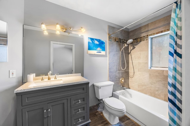 full bathroom featuring hardwood / wood-style floors, vanity, toilet, and shower / bath combo with shower curtain