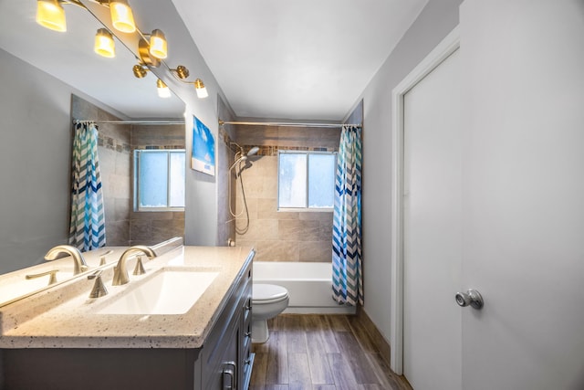 full bathroom with hardwood / wood-style floors, shower / bath combo, toilet, and vanity