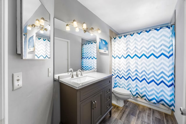 bathroom featuring vanity, curtained shower, toilet, and wood-type flooring