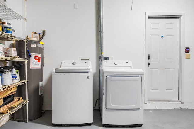 washroom featuring washing machine and clothes dryer and water heater