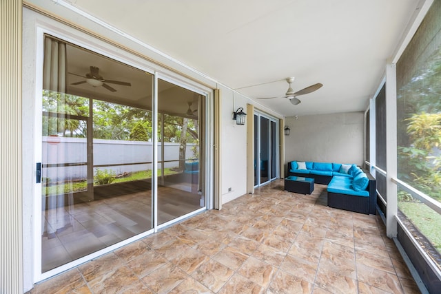 unfurnished sunroom featuring ceiling fan