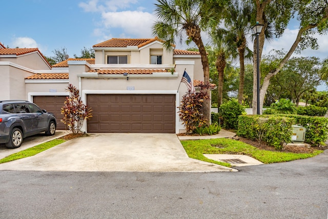 mediterranean / spanish-style home with a garage