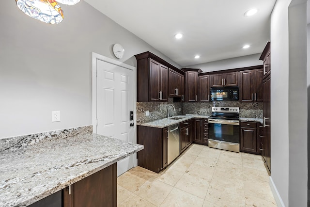 kitchen with sink, tasteful backsplash, light stone counters, dark brown cabinets, and appliances with stainless steel finishes