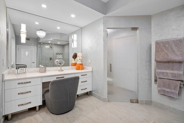 bathroom with vanity and a shower with door