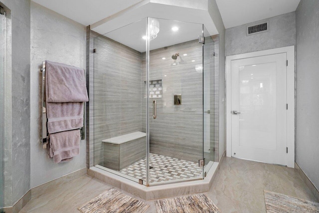 bathroom with a shower with door