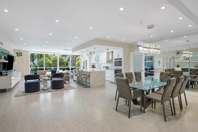 dining room featuring a wall of windows and sink