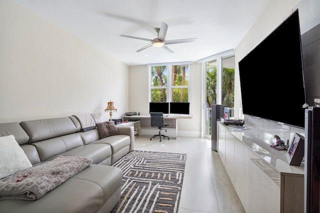 living room with ceiling fan and a wall of windows