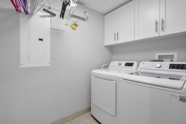 clothes washing area with electric panel, cabinets, and washing machine and dryer