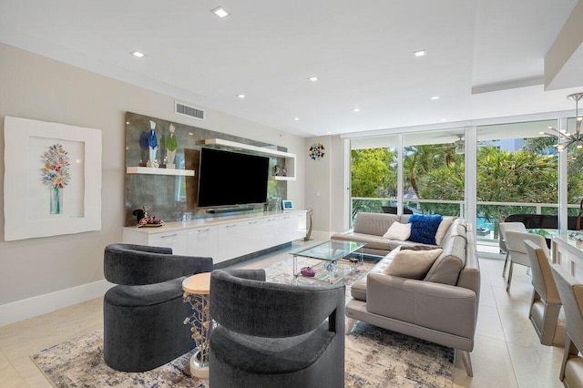 tiled living room featuring floor to ceiling windows