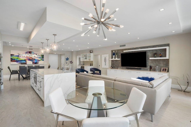 dining room featuring a raised ceiling and a notable chandelier