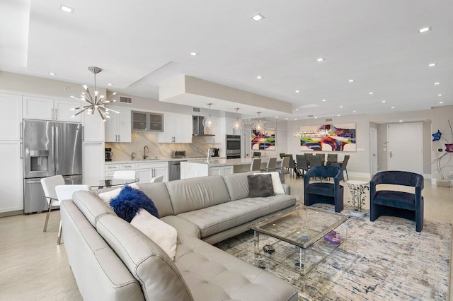 living room featuring an inviting chandelier and sink