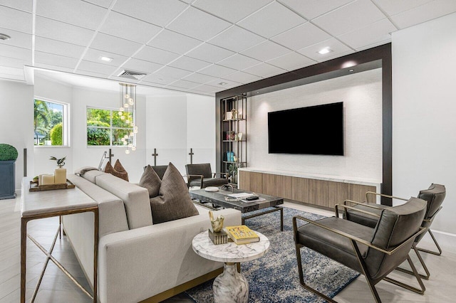 living room with a paneled ceiling