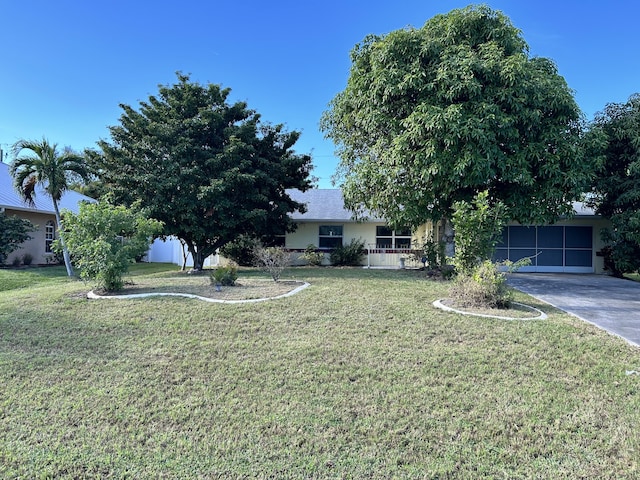 view of front facade with a front yard and a garage