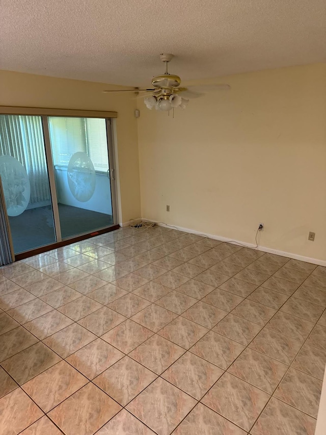 spare room with light tile patterned floors, a textured ceiling, and ceiling fan