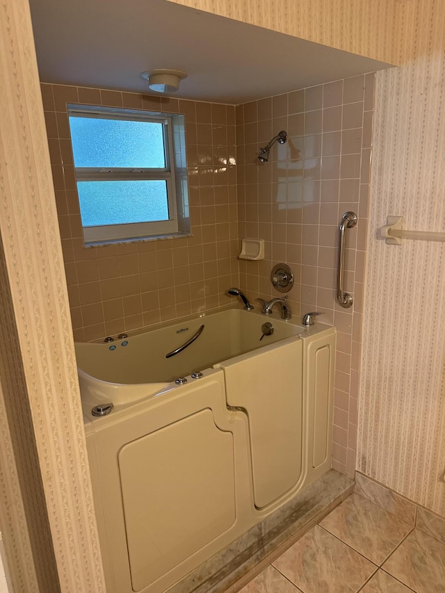 bathroom with tile patterned floors and tiled shower / bath combo