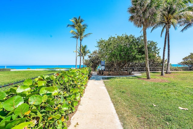 view of property's community featuring a water view and a lawn