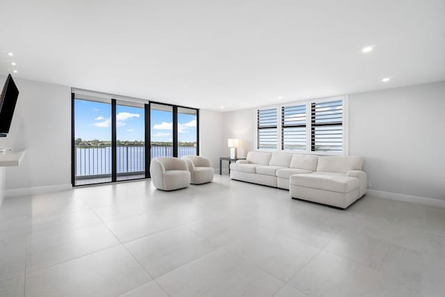 living room featuring expansive windows and a water view