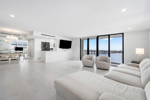 living room with a notable chandelier and expansive windows