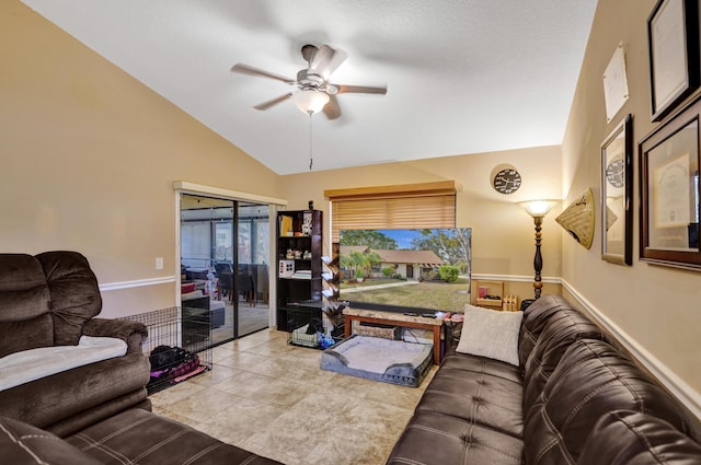 living room with ceiling fan, light tile patterned floors, and vaulted ceiling