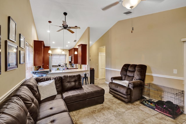 tiled living room featuring ceiling fan and high vaulted ceiling