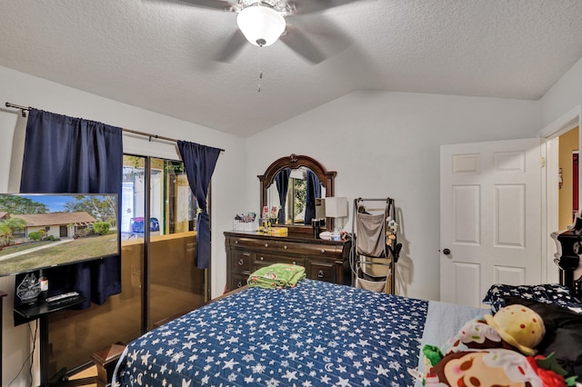 bedroom with ceiling fan, a textured ceiling, and vaulted ceiling