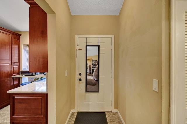 interior space featuring light tile patterned floors and a textured ceiling