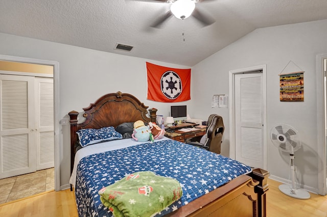 bedroom featuring a textured ceiling, hardwood / wood-style flooring, ceiling fan, and lofted ceiling