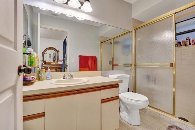 bathroom with vanity, toilet, and an enclosed shower