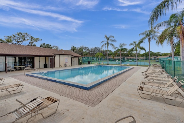 view of pool featuring tennis court