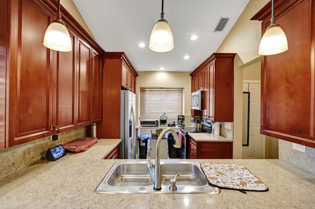 kitchen with decorative light fixtures, sink, decorative backsplash, and stainless steel appliances