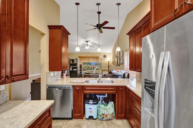 kitchen featuring ceiling fan, sink, stainless steel appliances, and decorative light fixtures