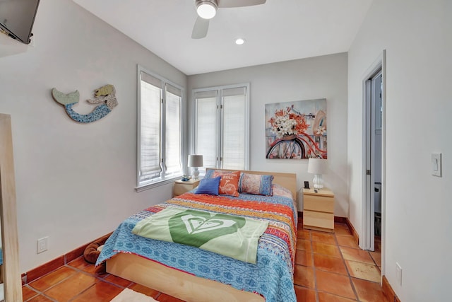 bedroom with ceiling fan and tile patterned floors