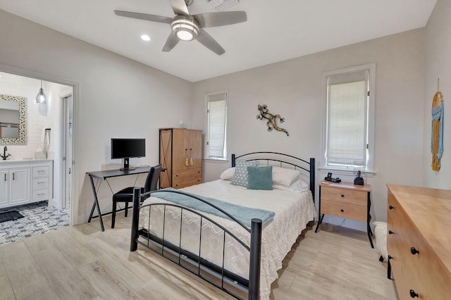 bedroom featuring ceiling fan, connected bathroom, and light wood-type flooring