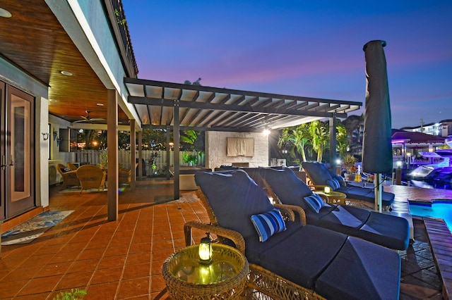 patio terrace at dusk featuring a pergola