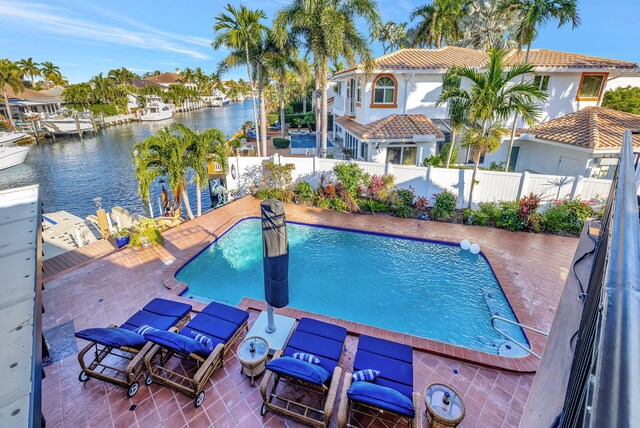 view of swimming pool with a deck with water view and a patio