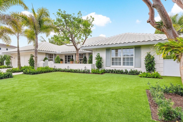 view of front facade with a front yard and a garage