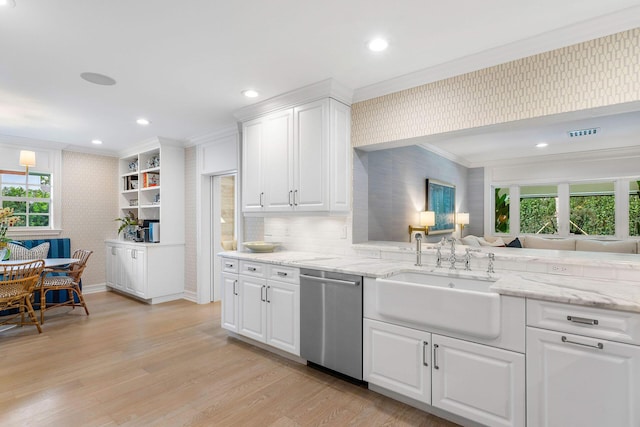 kitchen featuring white cabinetry, dishwasher, sink, light hardwood / wood-style flooring, and ornamental molding