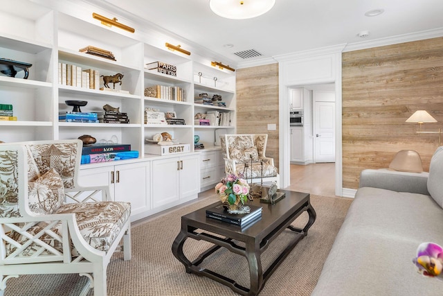 living room with wood walls and ornamental molding