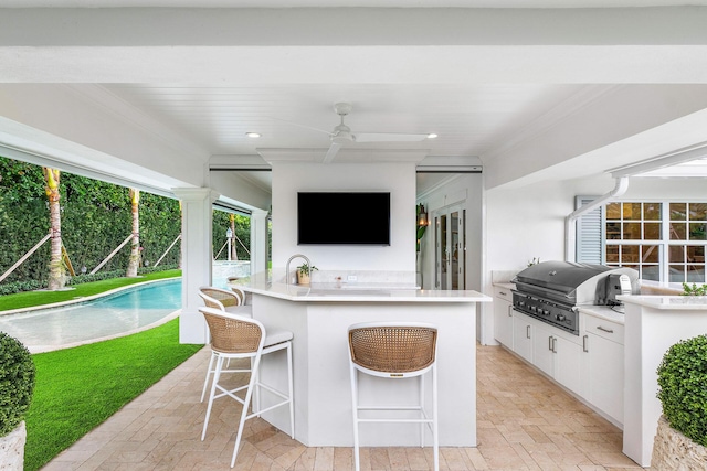 view of patio with an outdoor bar, grilling area, and exterior kitchen