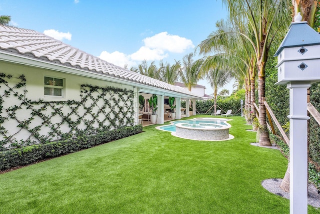 view of yard with an in ground hot tub and a patio