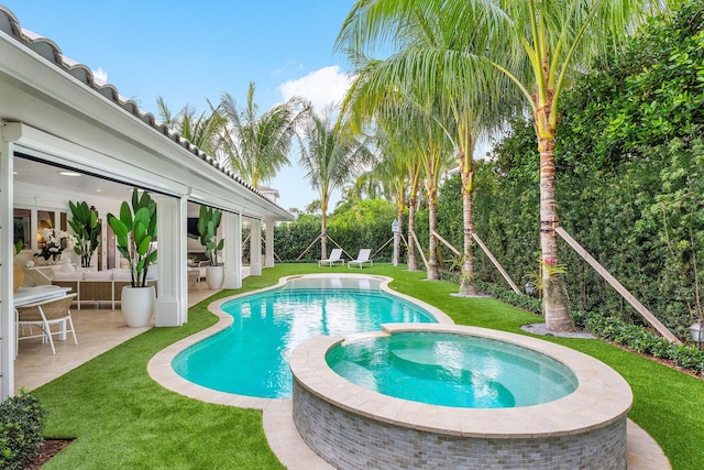 view of pool with a lawn, outdoor lounge area, an in ground hot tub, and a patio