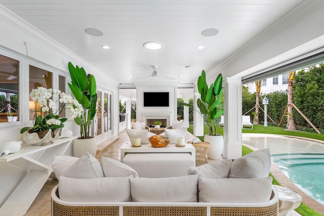 living room with ceiling fan and crown molding