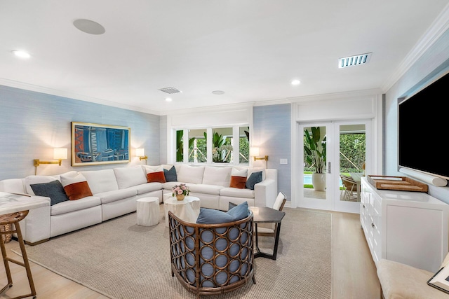 living room with ornamental molding, light hardwood / wood-style flooring, and french doors