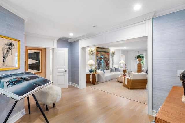 living room with wood-type flooring and crown molding