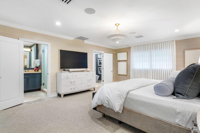 bedroom with connected bathroom and ornamental molding